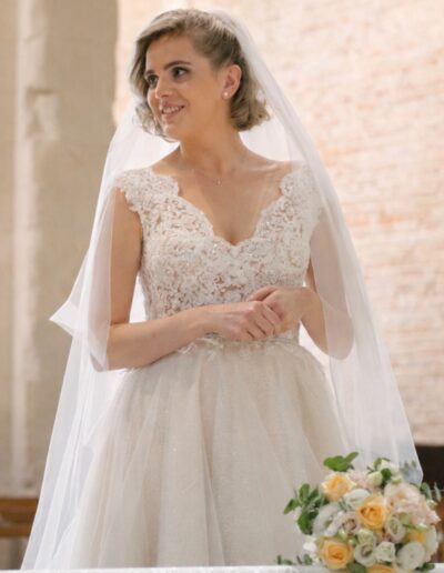 Sposa in abito componibile Sposa Musa con corpetto in pizzo ricamato nella chiesa Santa Maria di Ronzano, Teramo.